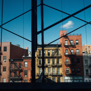 VIEW OF NEW YORK SKYLINE THROUGH WINDOWS AND SCAFFOLDING