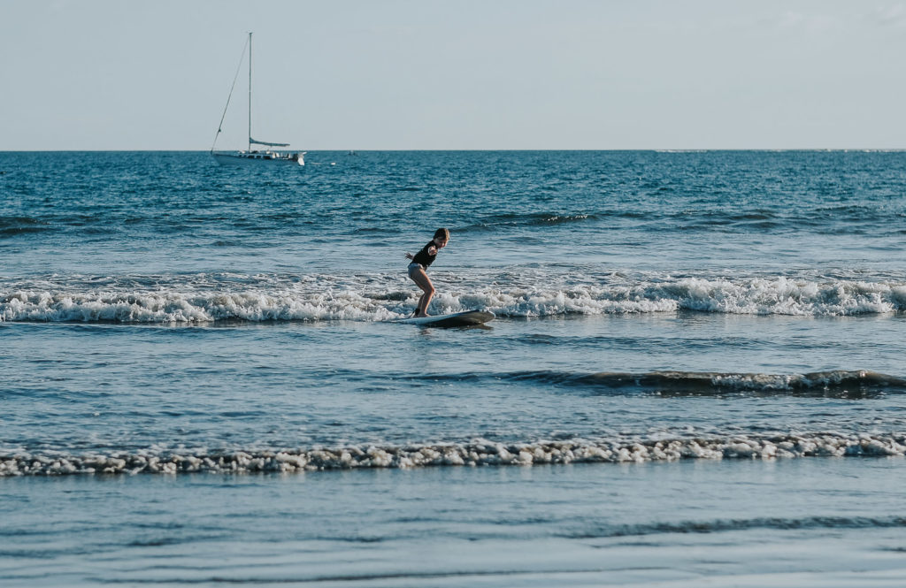 six year old girl surfing at playa samara in costa rica wedding photographer