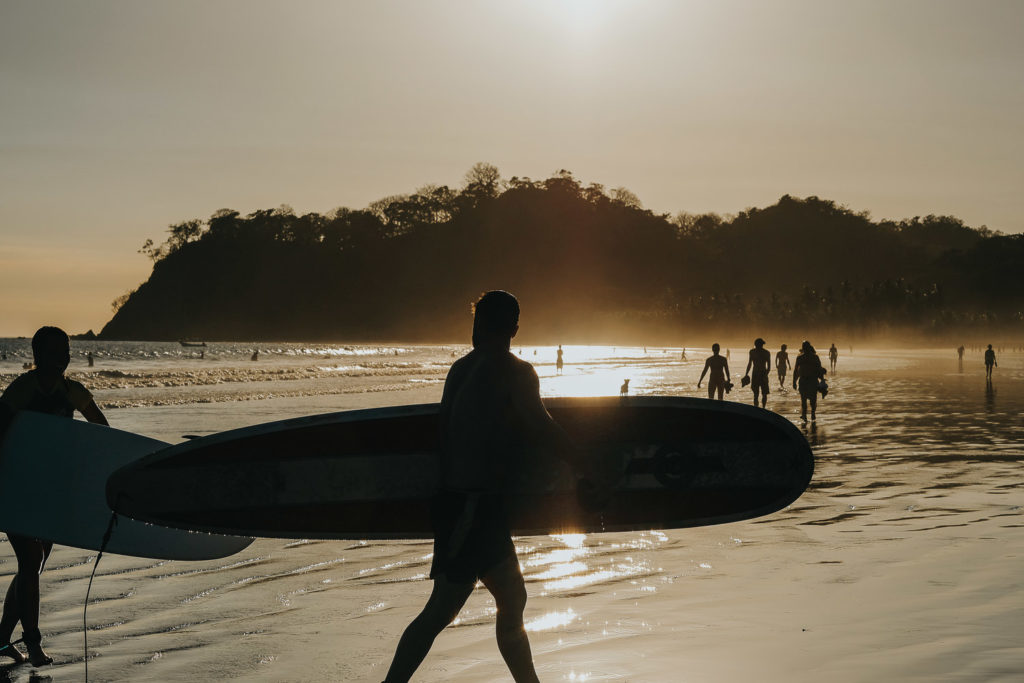 sillhouette of surfers at sunset costa rica playa samara beach