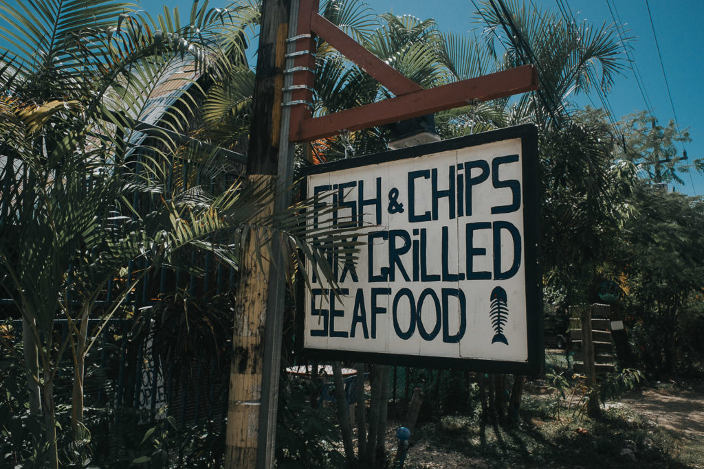 food menu restaurant sign at playa samara costa rica tropical palm trees