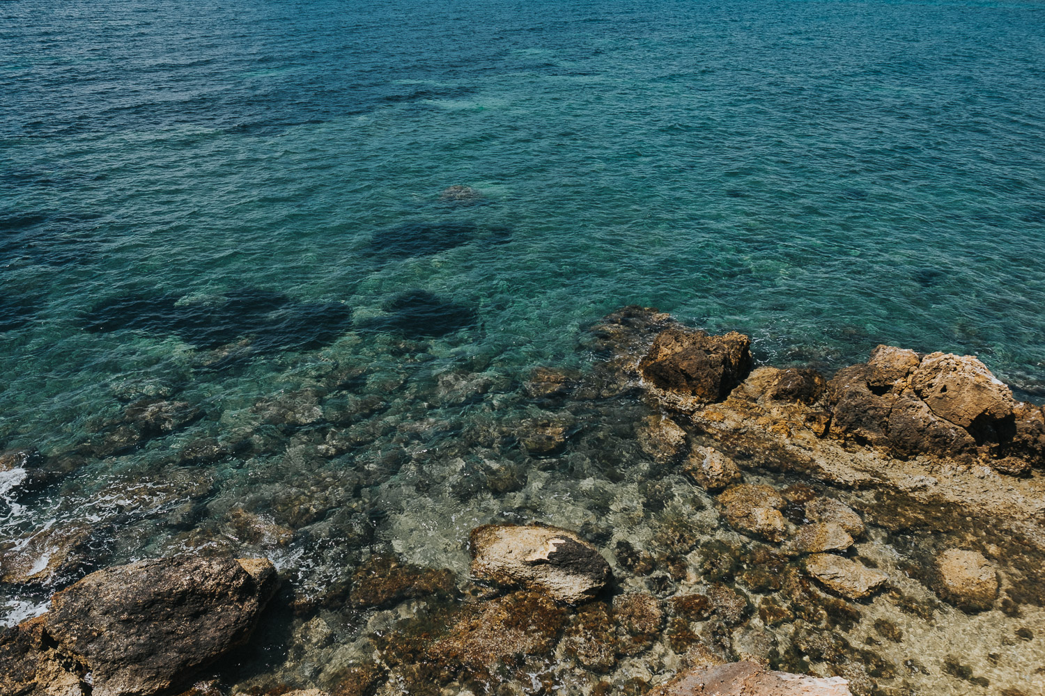 destination wedding photographer prices blue sea close up in ibiza