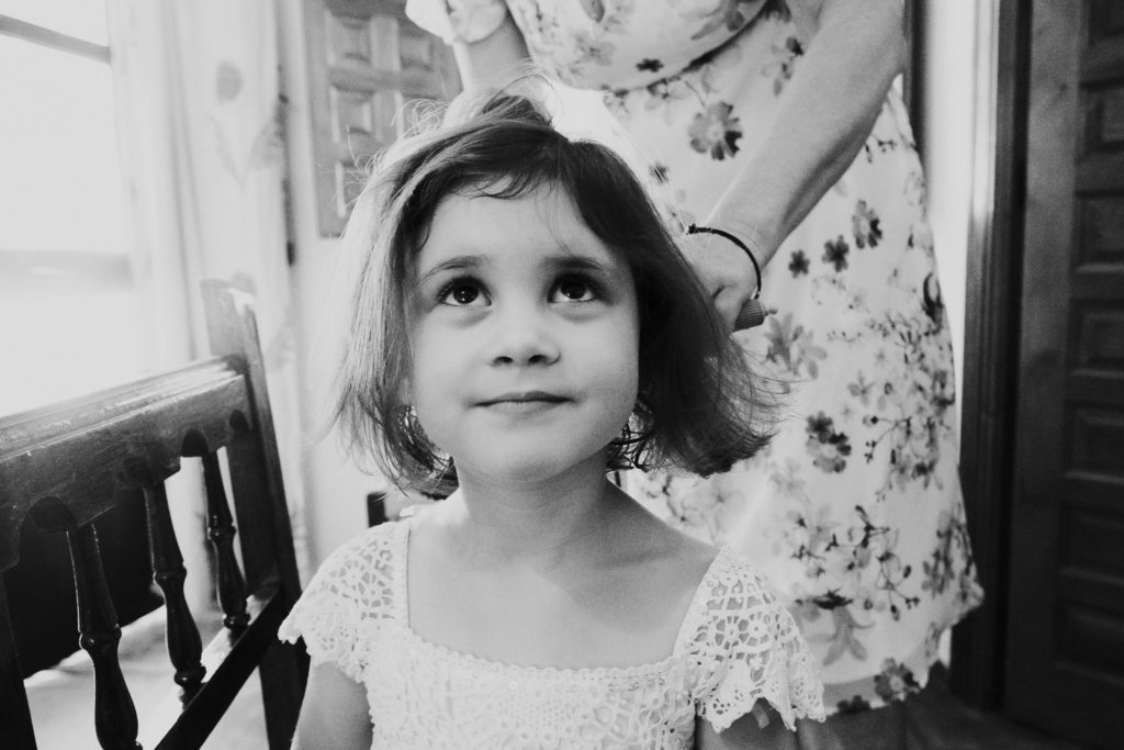 small girl having hair blow dried black and white jerez wedding photographer