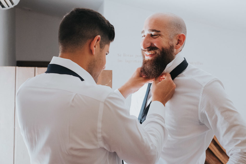 groom getting ready putting tie on jerez wedding photographer 