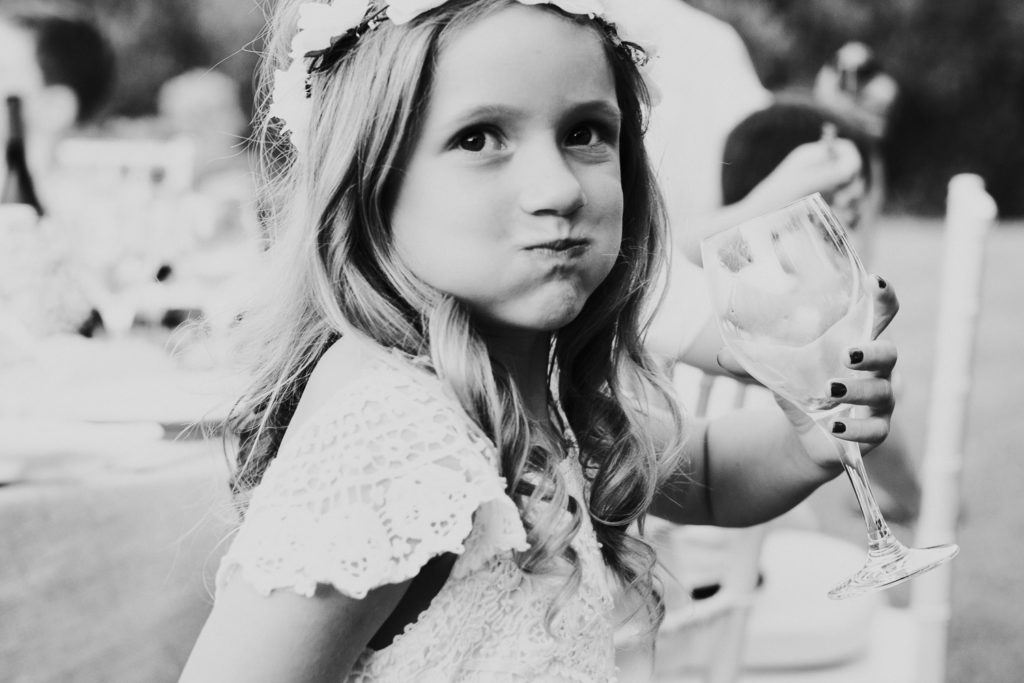 little girl at wedding big sip mouth full wine glass black and white jerez wedding photographer