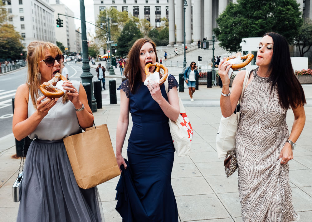 bridesmaids eating pretzels on street new york city elopement