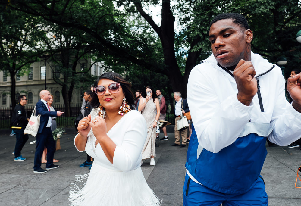 New York City destination wedding bride dancing with street dancer
