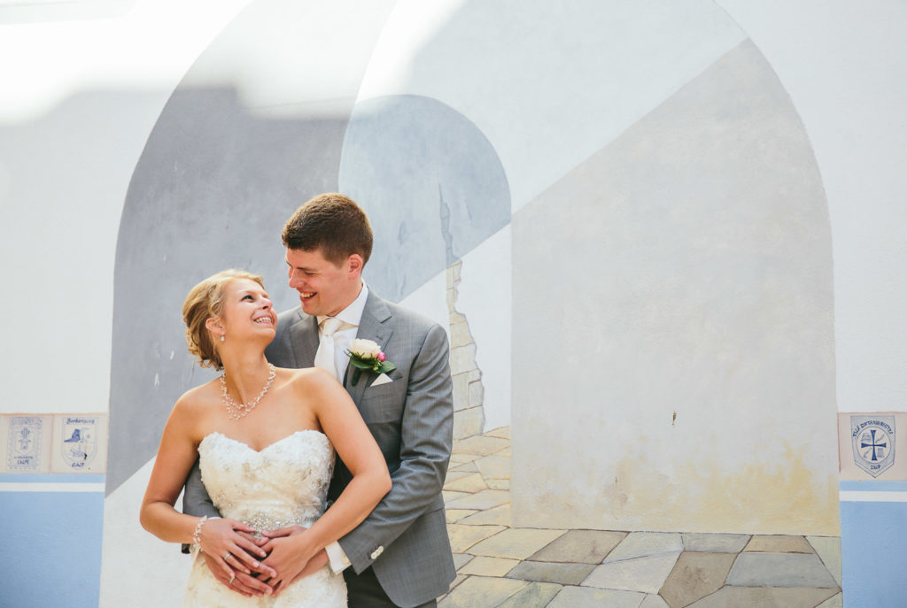 SOL Y MAR CALPE COSTA BLANCA WEDDING PHOTOGRAPHER BRIDE AND GROOM STANDING IN FRONT OF MURAL