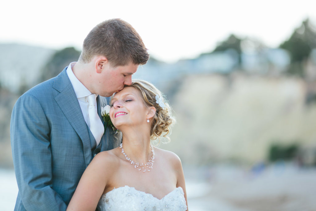 SOL Y MAR CALPE COSTA BLANCA WEDDING PHOTOGRAPHER BRIDE AND GROOM KISSING ON BEACH