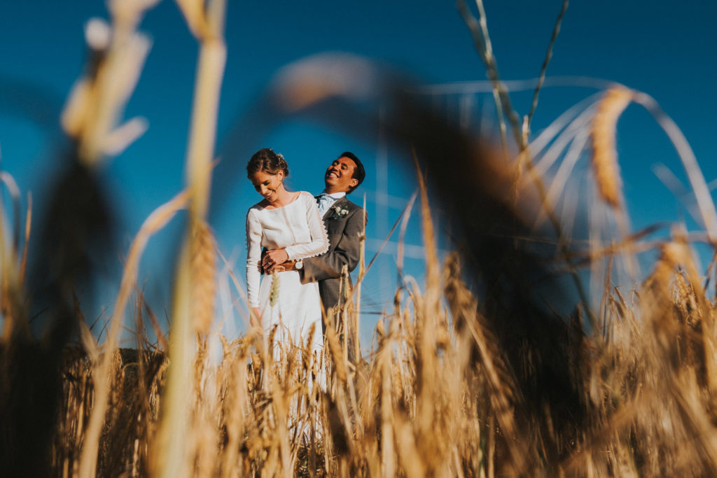 kent wedding photographer bride and groom in wheat field in summer blue sky in kent