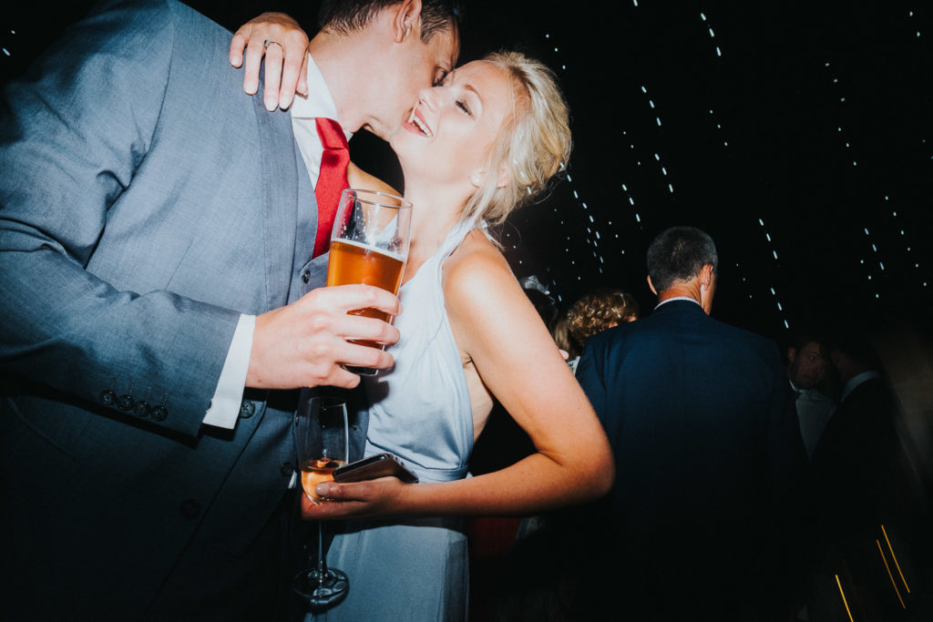 couple at wedding drinking beer on dancefloor kent wedding photographer