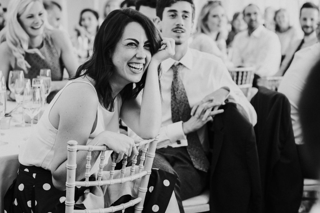 kent wedding photographer black and white photo of guest laughing