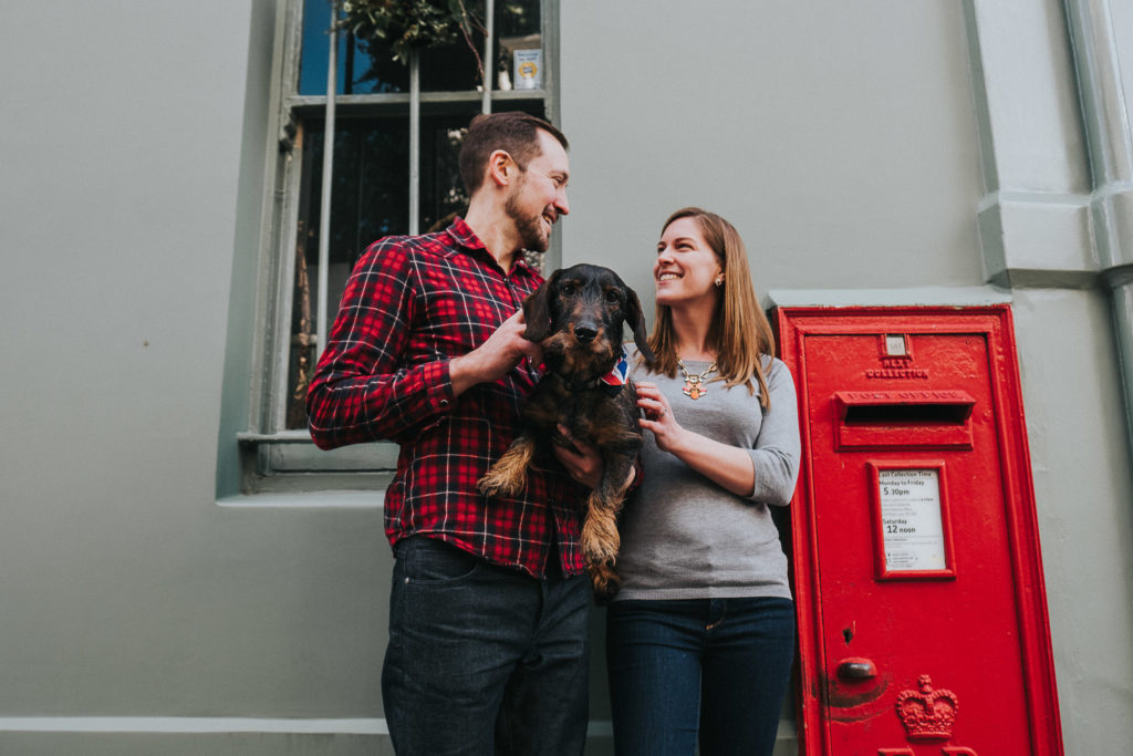 COUPLE WITH SAUSAGE DOG BY RED POST BOX LONDON PHOTO SHOOT